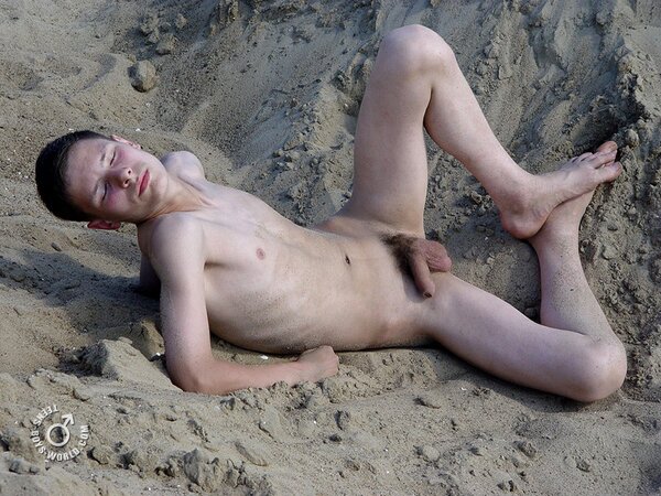 Fima enjoys rolling in the sand while completely naked