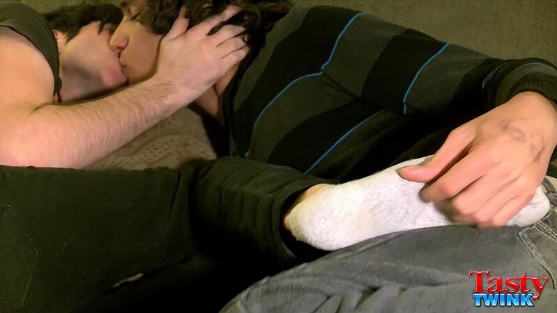 Tristan and Aron share a romantic kiss while touching feet