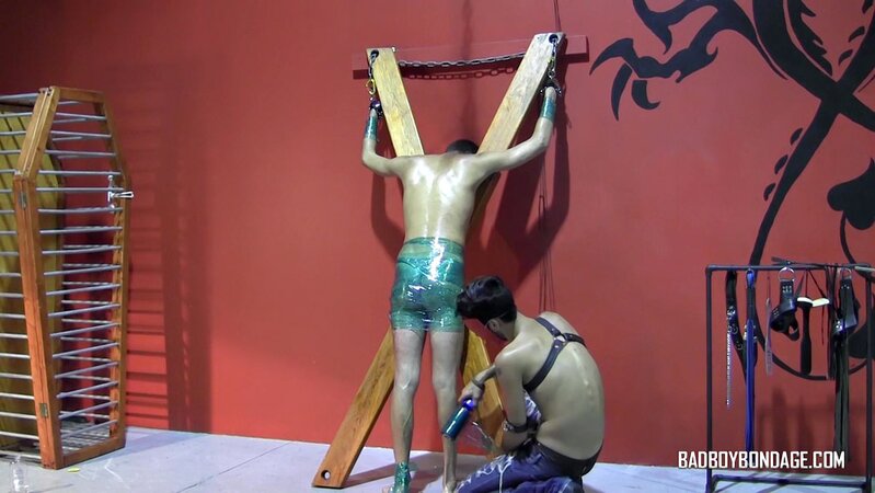 Ryann Ruckers torments Justin Martinez on the bondage cross