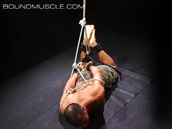 Hogtied Joseph Draggon fights for freedom from his restraints