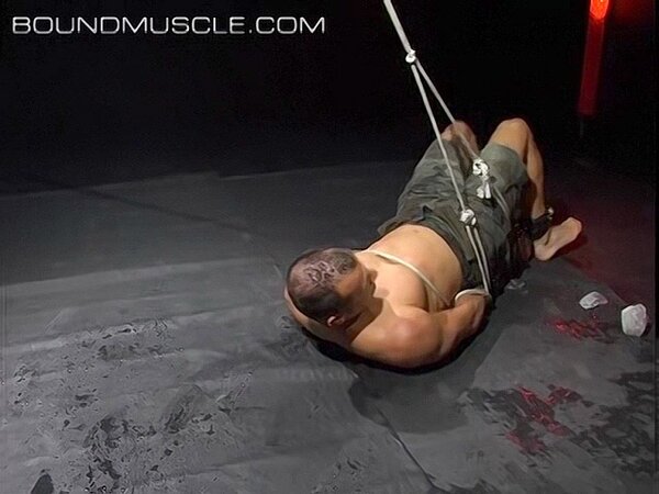 Hogtied Joseph Draggon fights for freedom from his restraints