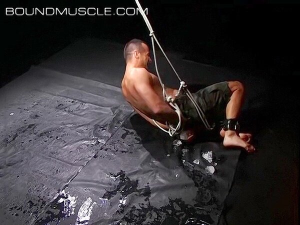 Hogtied Joseph Draggon fights for freedom from his restraints