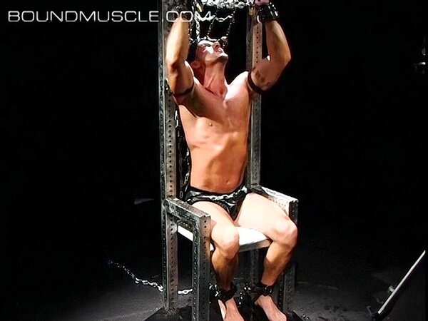 Erik Kelso struggles in bondage with chains while seeking his freedom