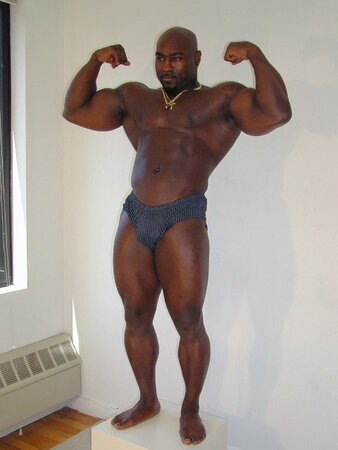 Black and muscled Dynamite shows off bare feet