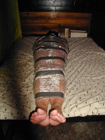 Bondage masters mummify a guest Craig in a plastic wrap