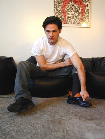 Brunette Christopher flaunts his feet in dark socks for the camera