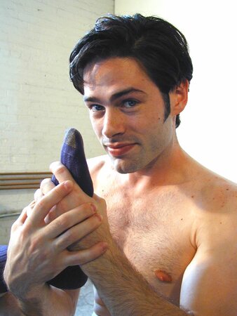 Brunette Christopher flaunts his feet in dark socks for the camera