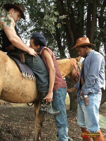 Slim guy sandwiched between 2 cowboys